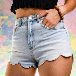 Denim shorts with frill on the bottom.
